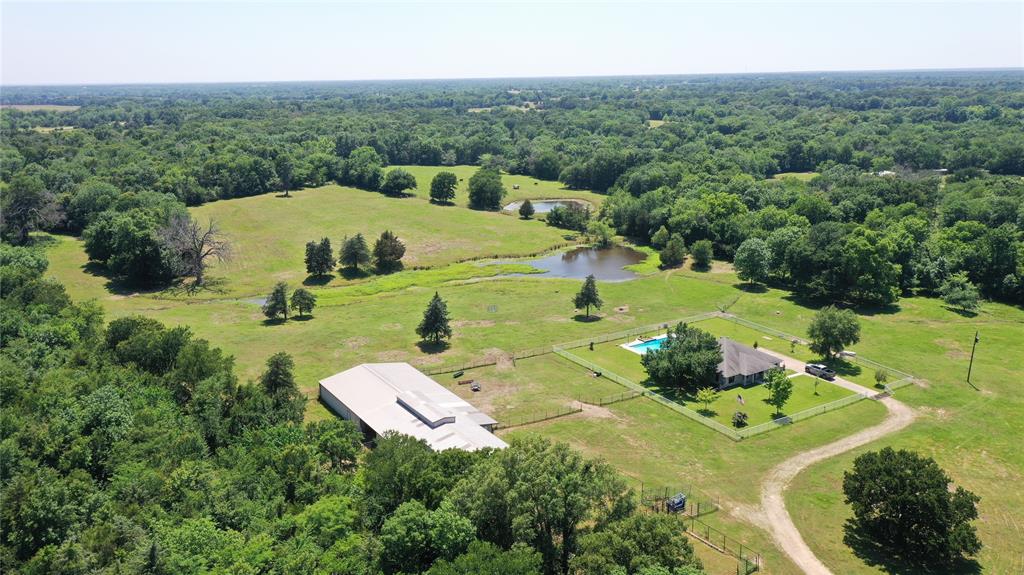 an aerial view of a house with yard