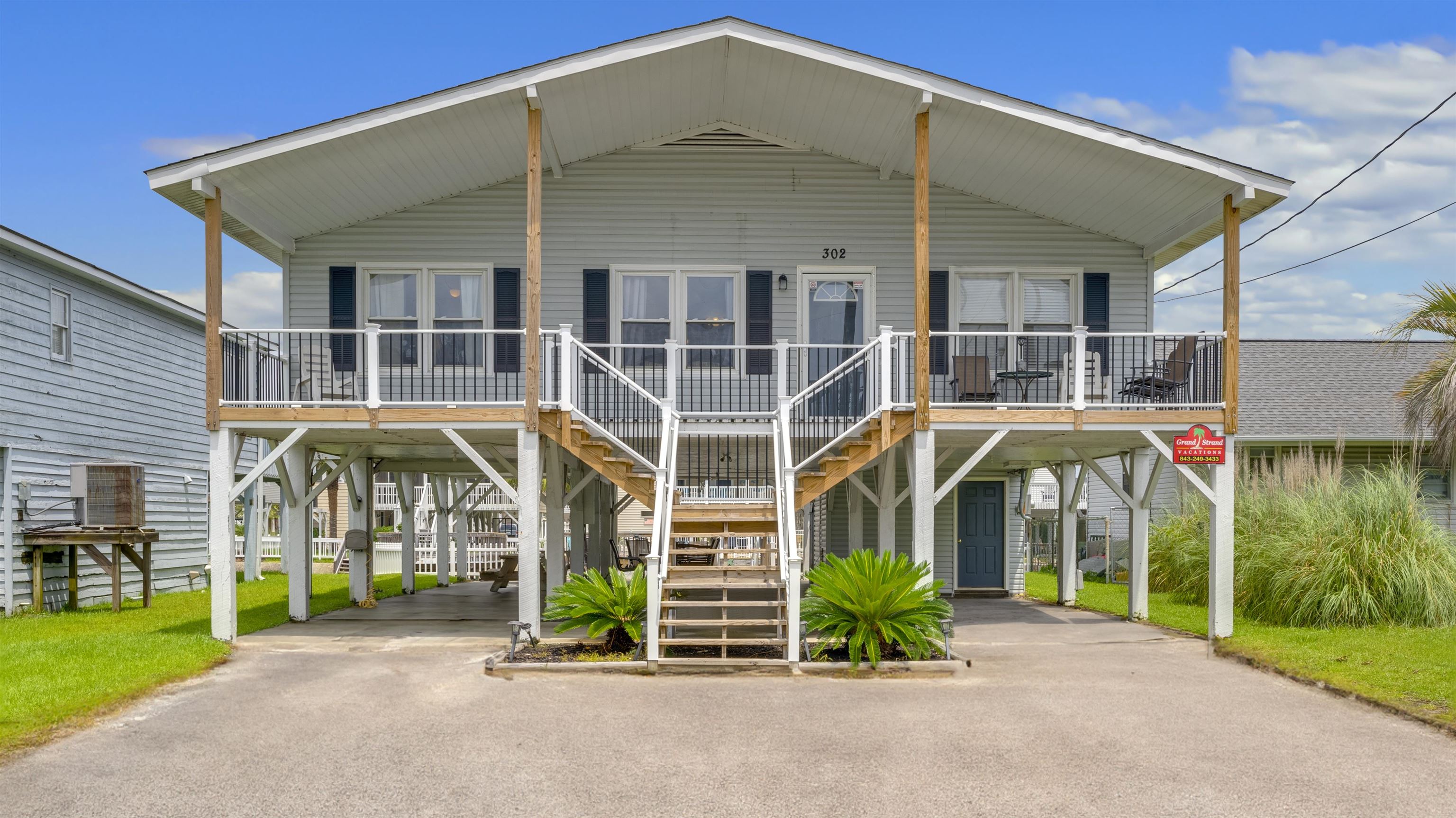 Coastal home featuring a carport and a porch