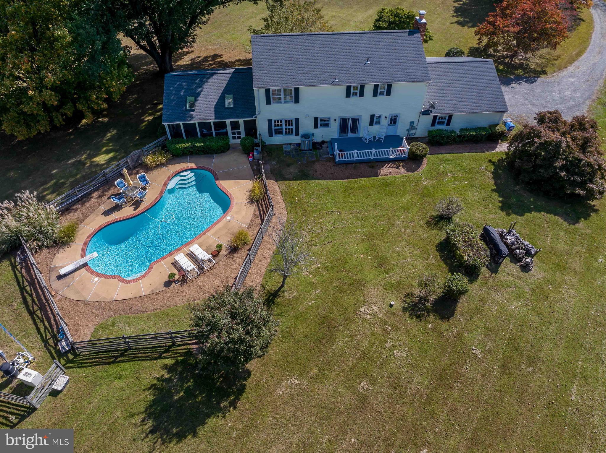 an aerial view of house with yard swimming pool and outdoor seating