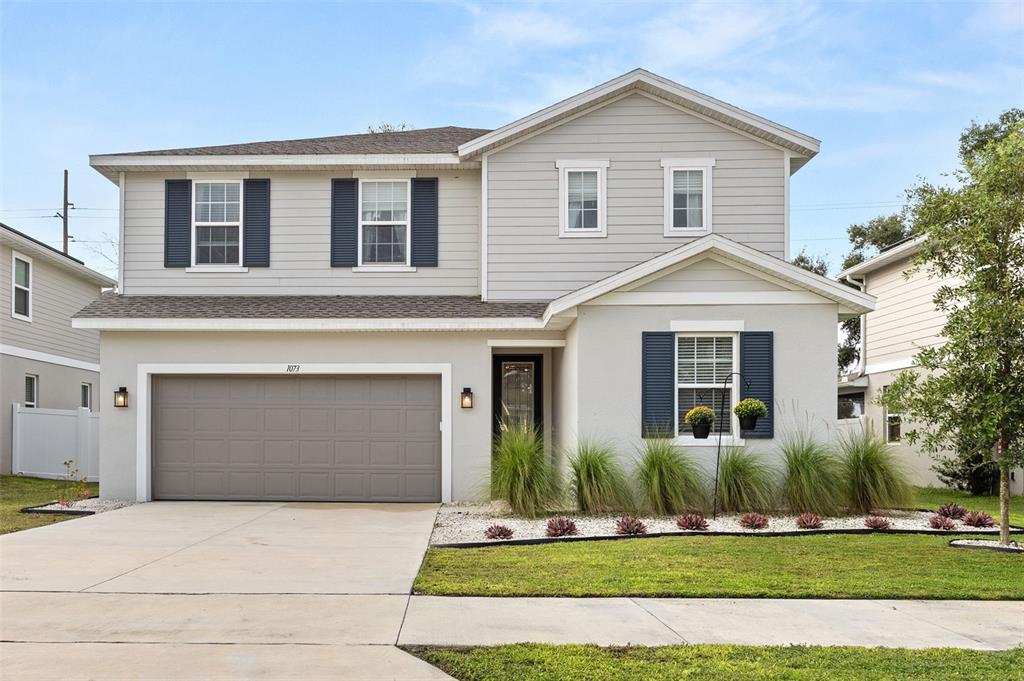 a front view of a house with a yard and garage