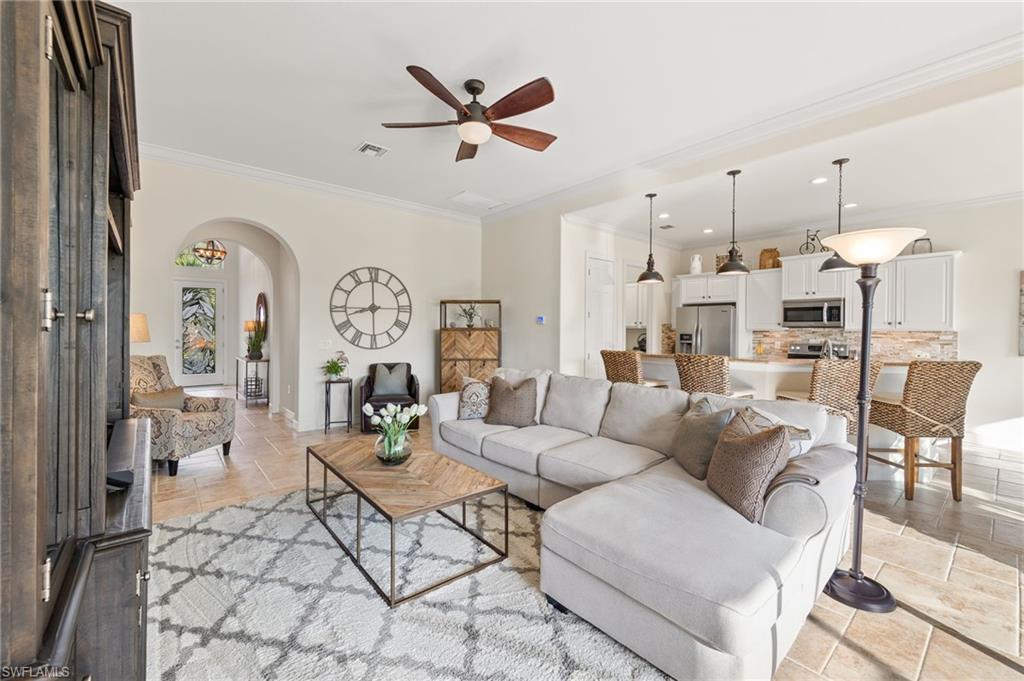 a living room with furniture a clock and a chandelier