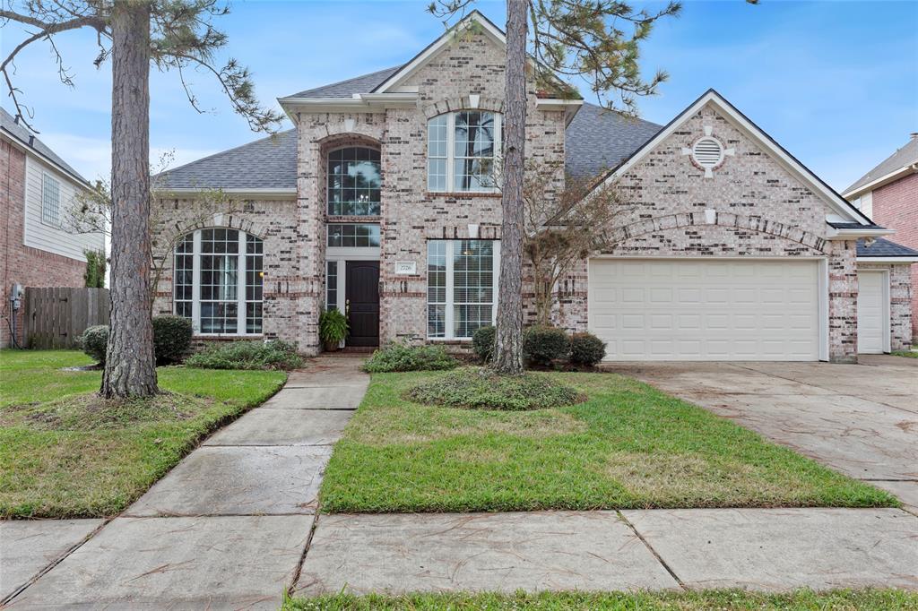 Beautiful two story home with big windows and detailed brickwork!