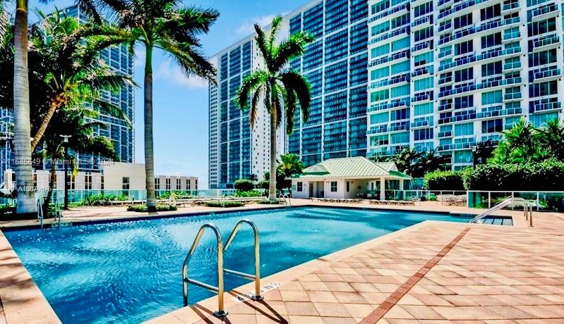 a swimming pool with outdoor seating and yard