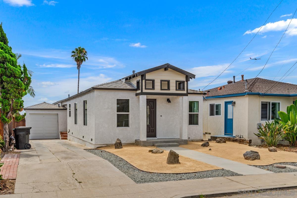 a view of a house with yard and sitting area