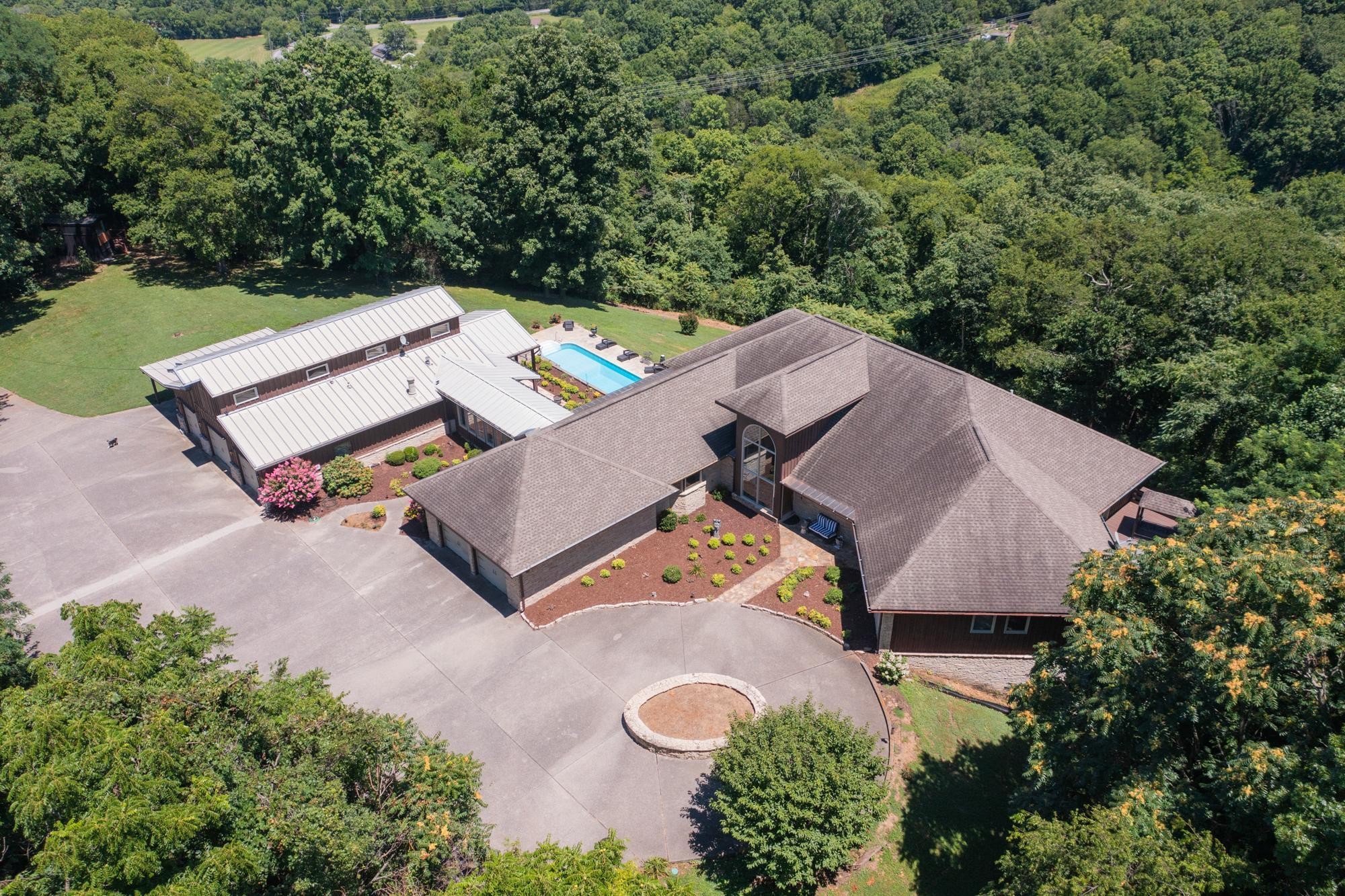 an aerial view of a house with yard swimming pool and outdoor seating