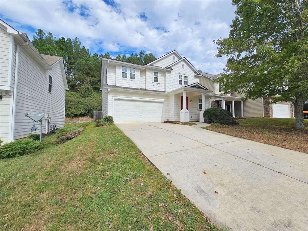 a front view of a house with a garden