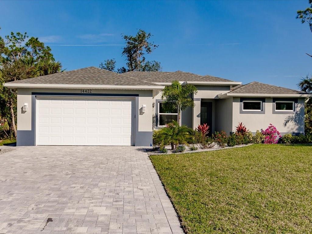 a front view of a house with a yard and garage