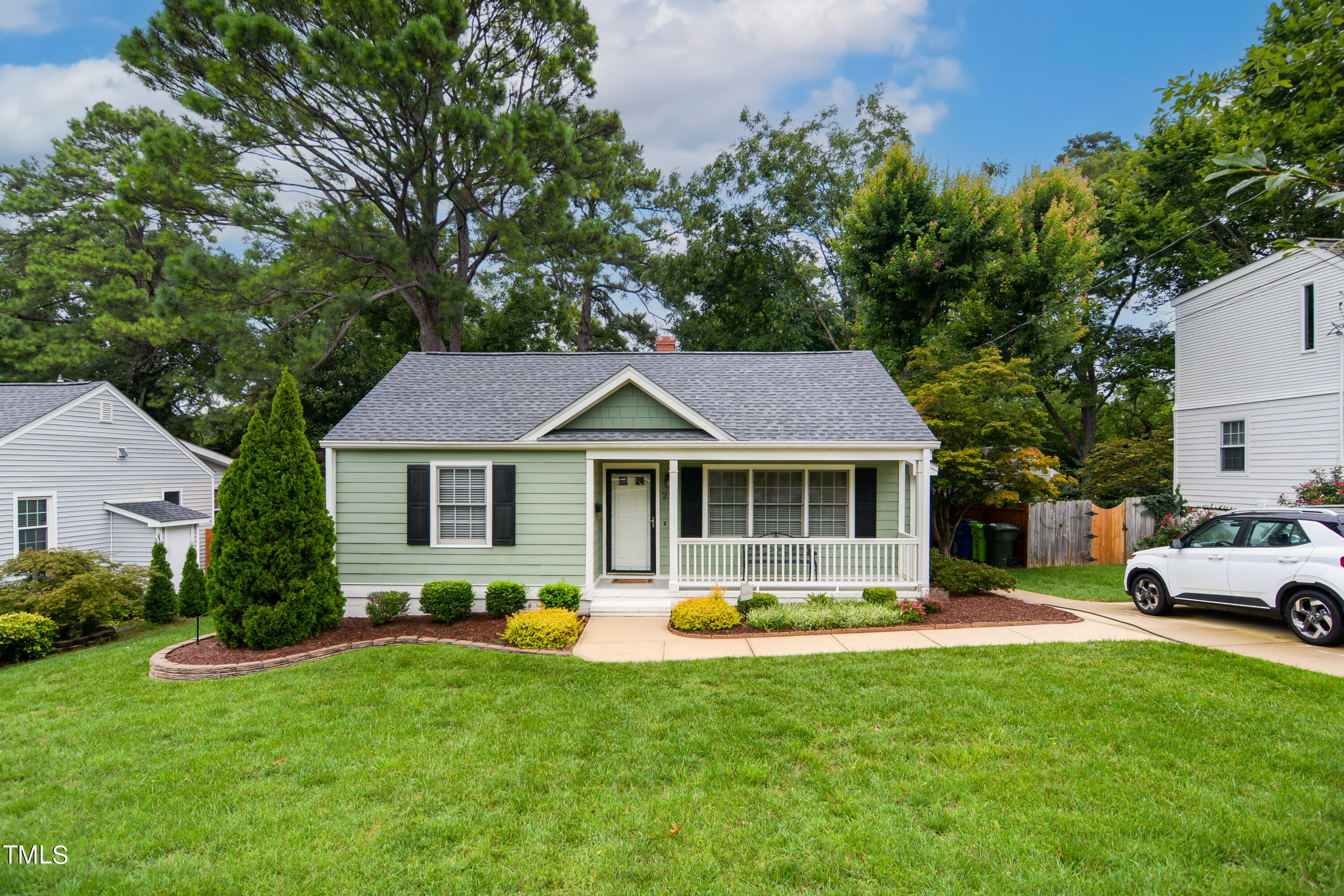 a front view of house with yard and green space