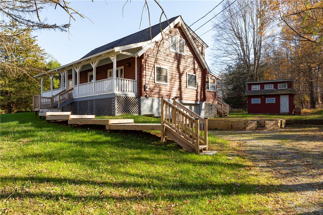 a view of a house with backyard and sitting area