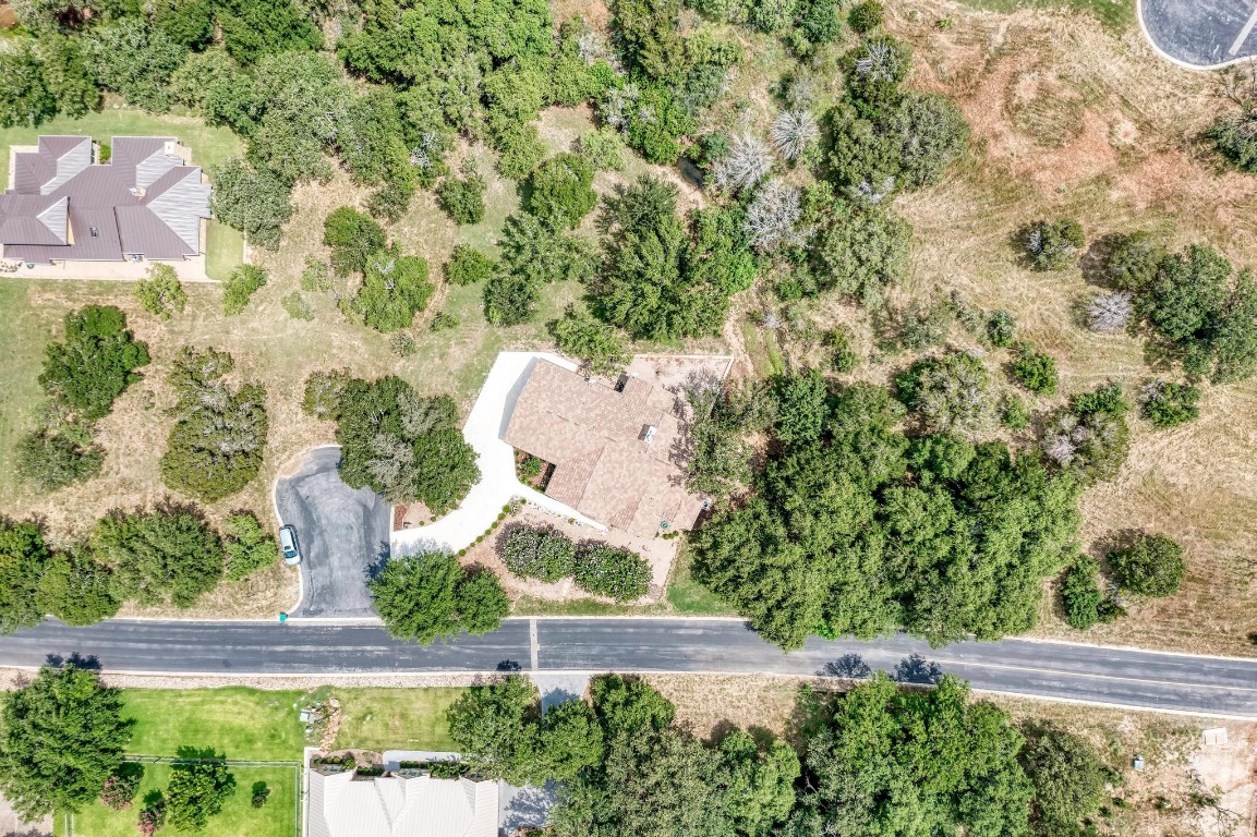 an aerial view of a house with garden space and street view