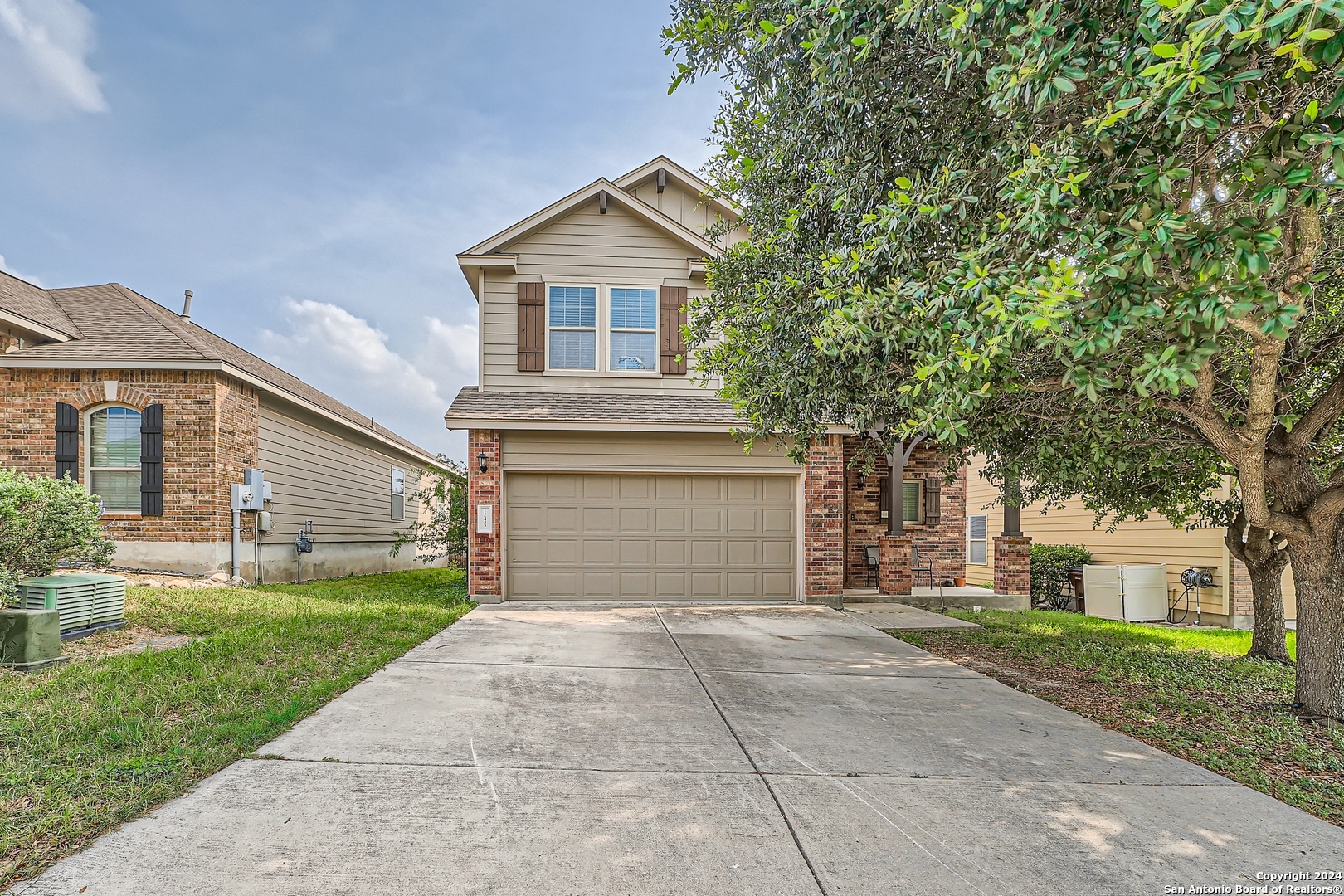 a front view of a house with a yard and garage