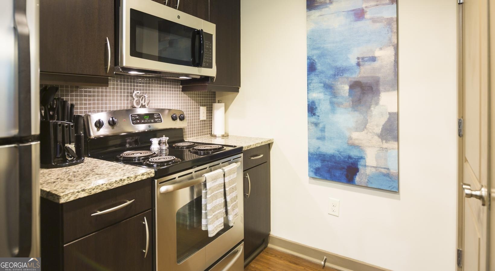 a kitchen with a stove and a microwave