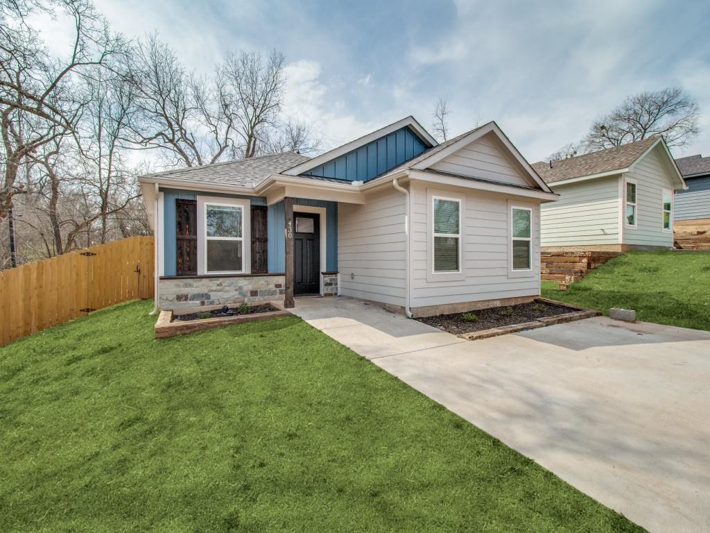 a view of a house with a yard and fence