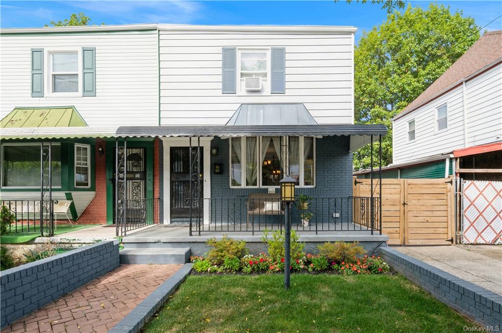 View of front of home featuring a front lawn and a porch