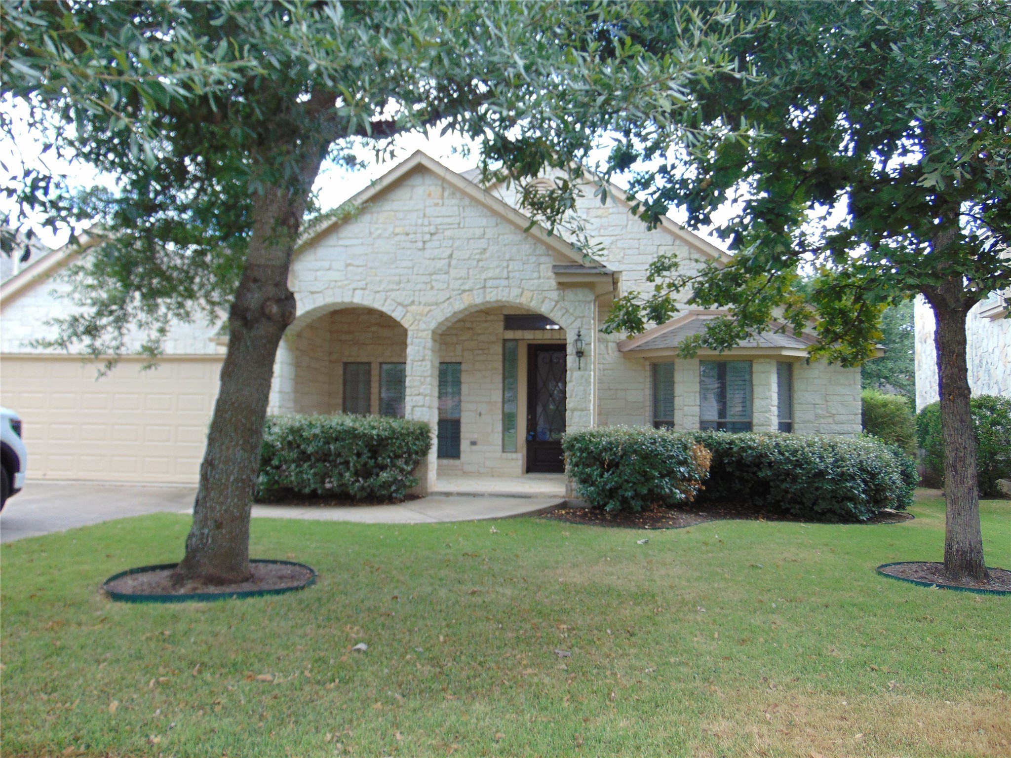 a front view of a house with a yard and garage