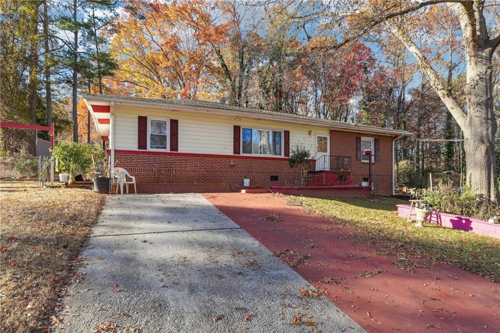 a front view of house with yard and trees around