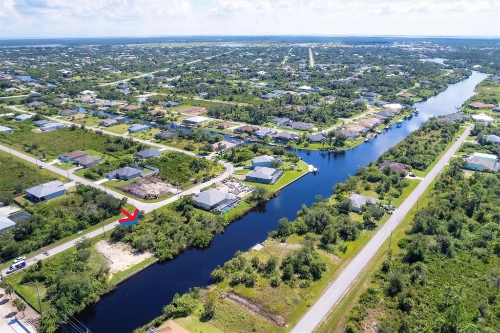 an aerial view of lake and residential houses with outdoor space