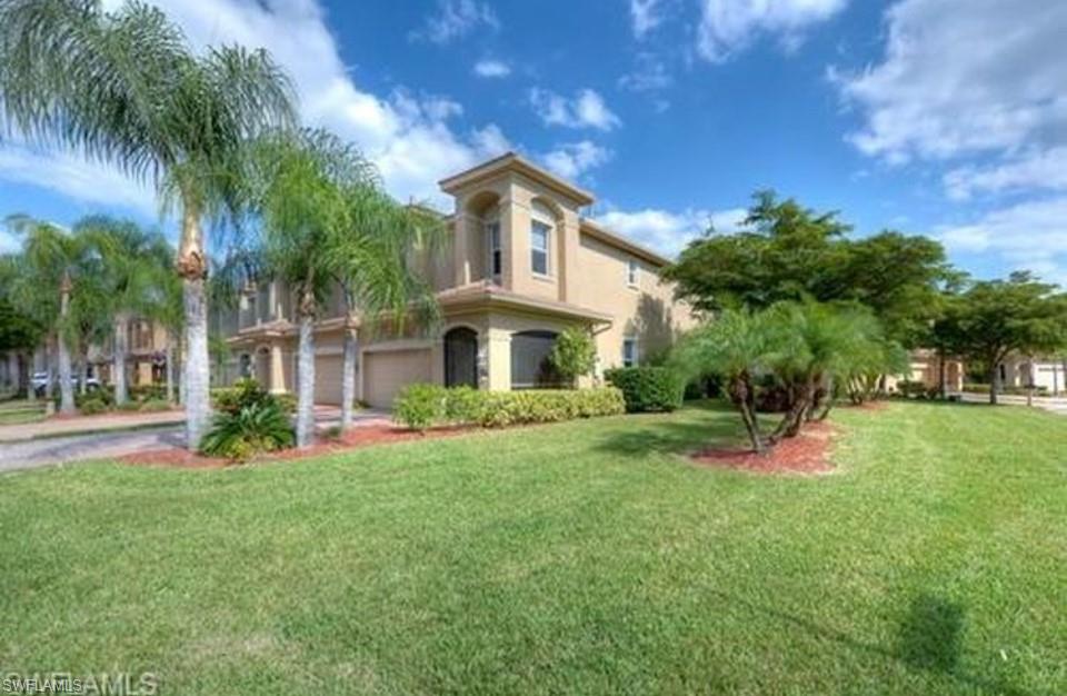 a front view of house with yard and green space