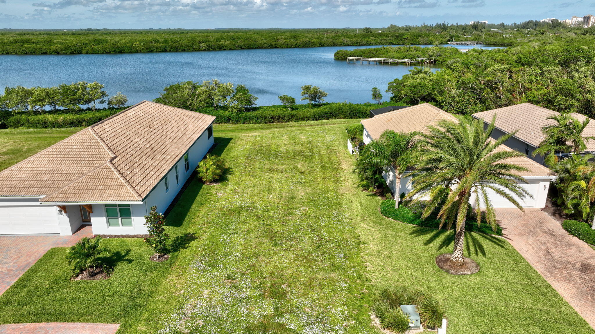 a view of a lake with a house and a big yard