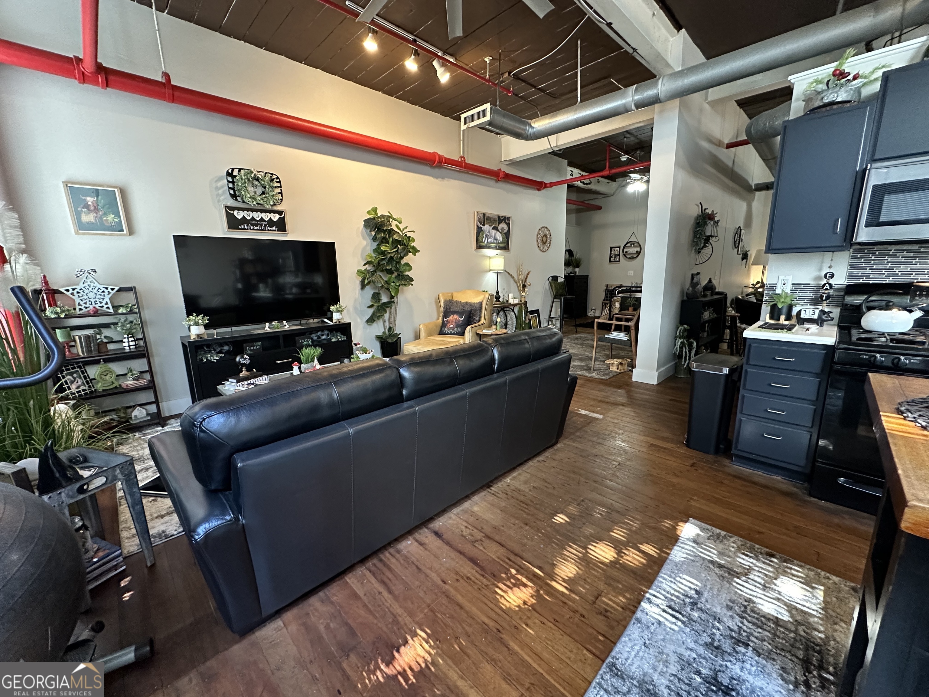 a living room with furniture and a flat screen tv