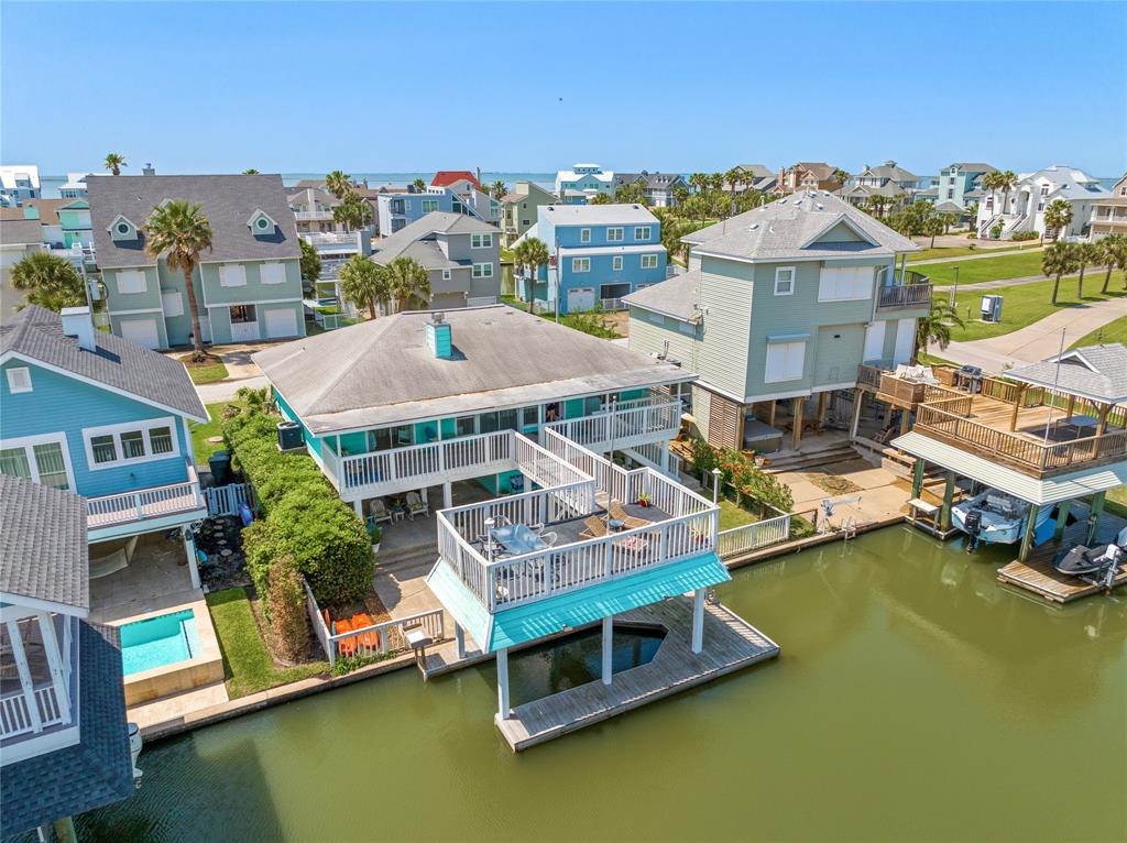 a view of a house with pool lawn chairs and a yard