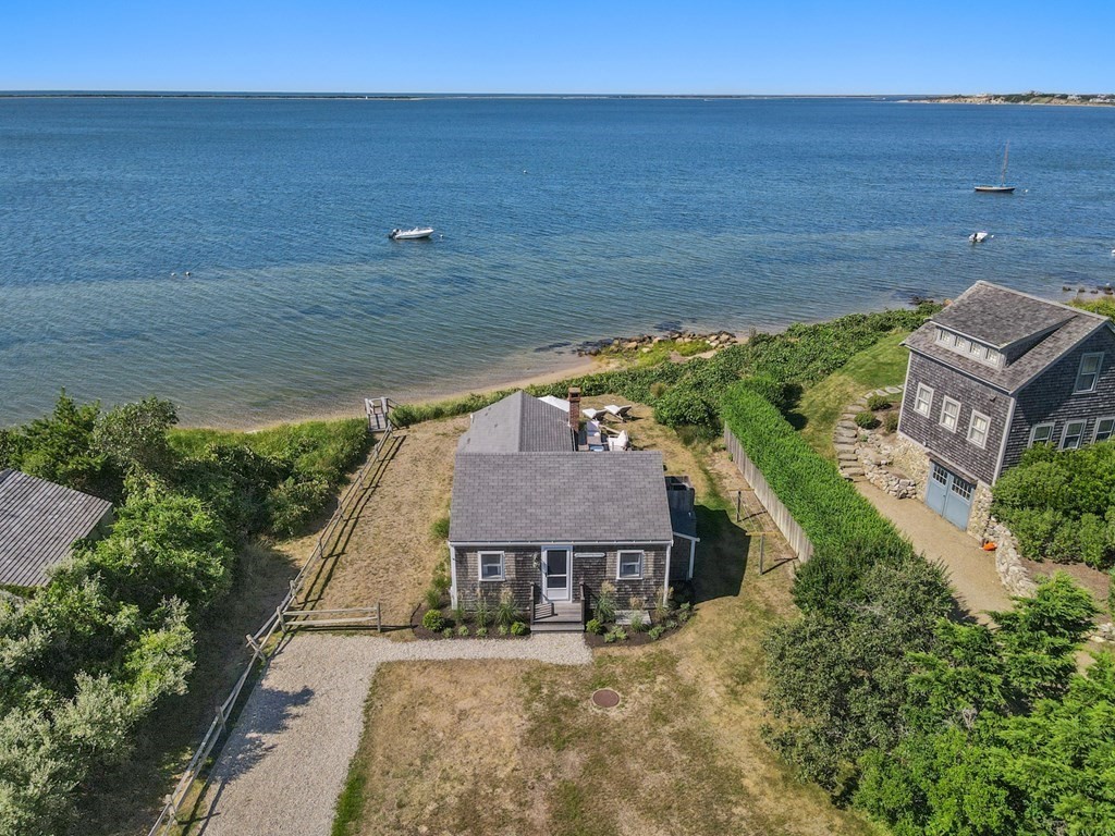 an aerial view of a house with a yard