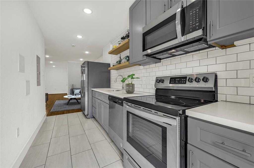 a kitchen with stainless steel appliances granite countertop a stove and a microwave