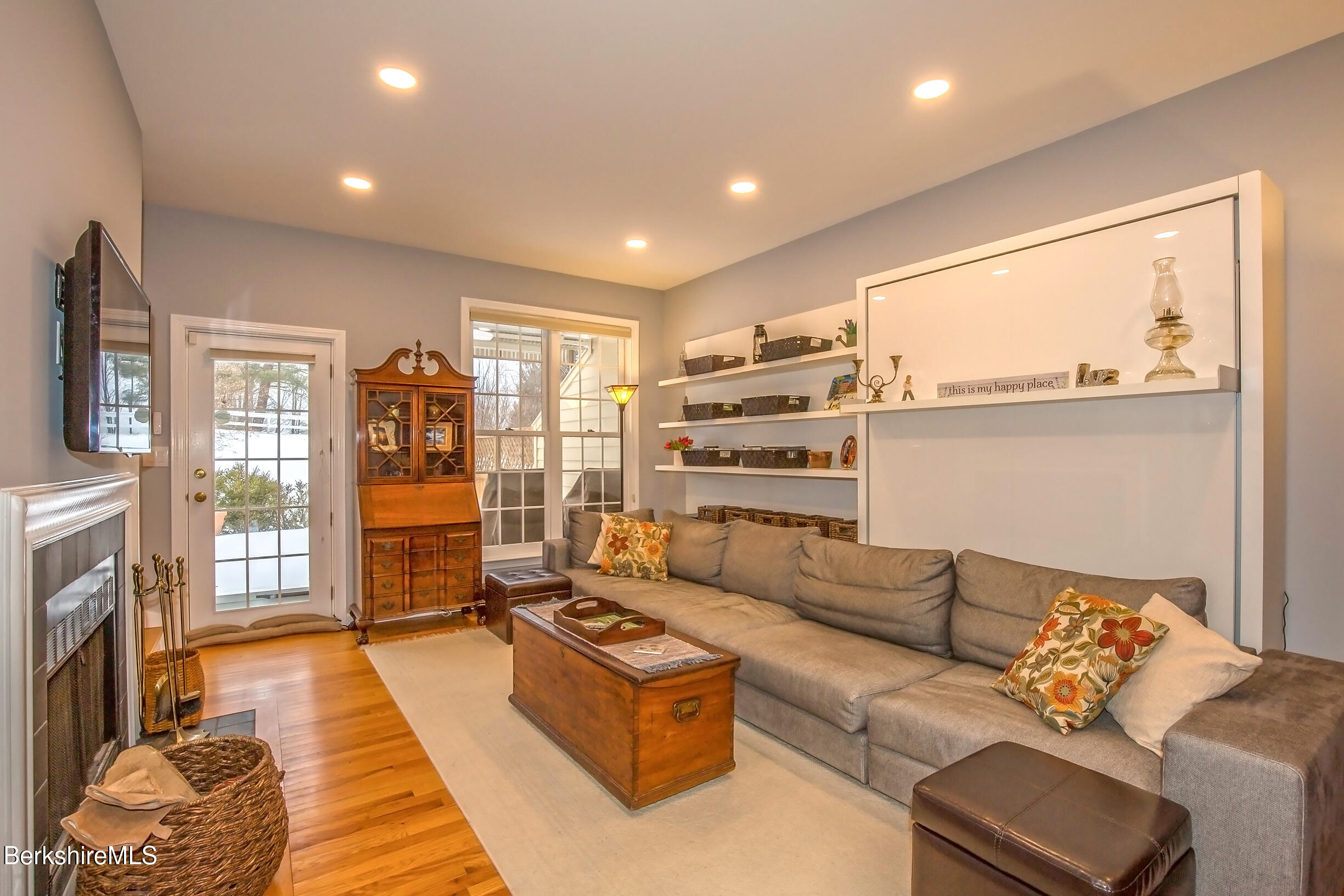 a living room with furniture and a fireplace