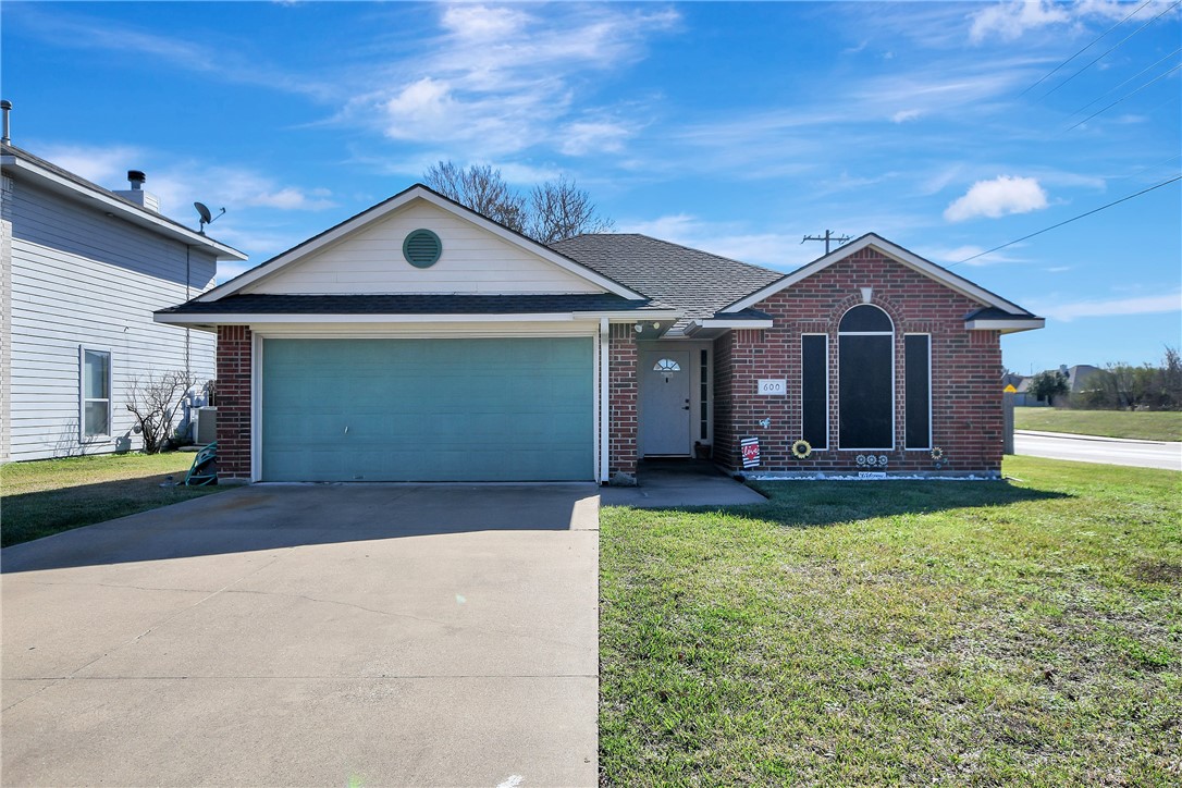 Single story home featuring a garage and a front l