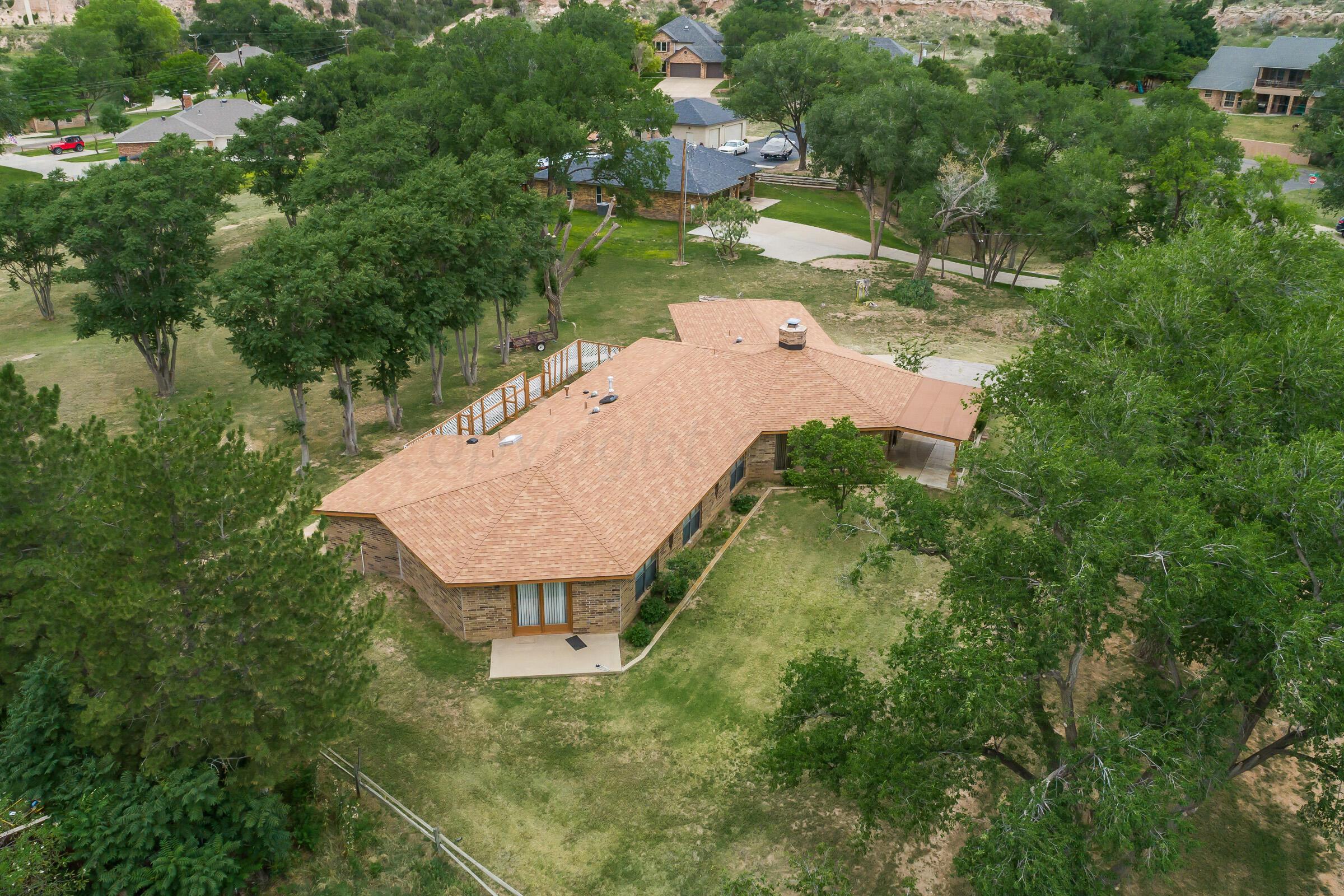 an aerial view of a house with yard swimming pool and outdoor seating