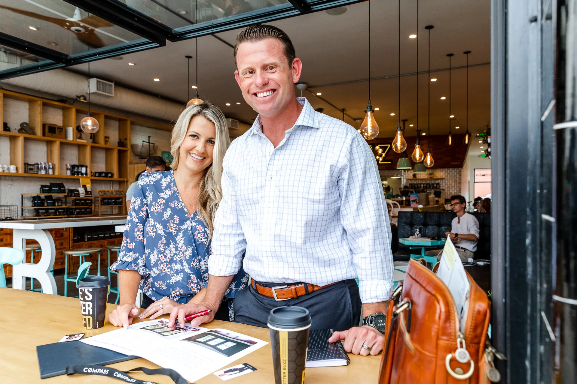 A man and woman standing in front of a piano.