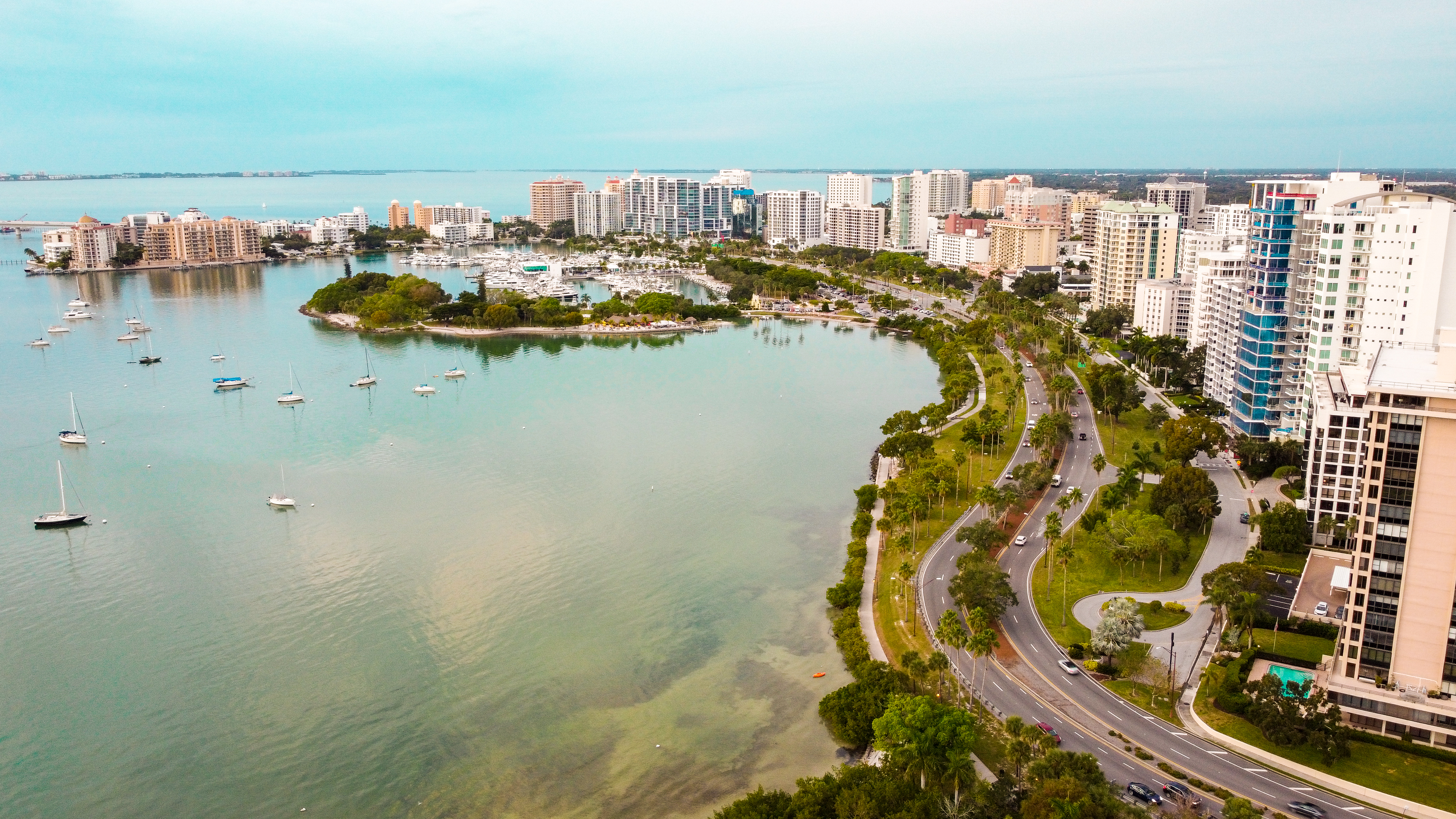 The caption for the given image is A large body of water with a city.