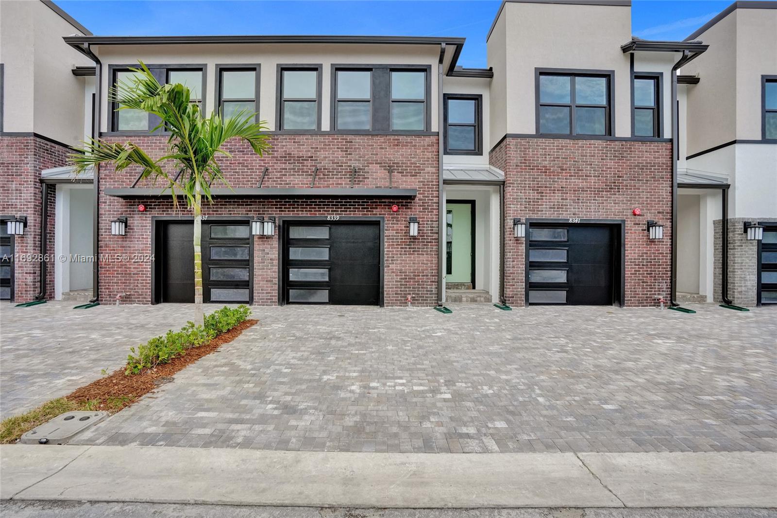 a front view of a house with a yard and a garage