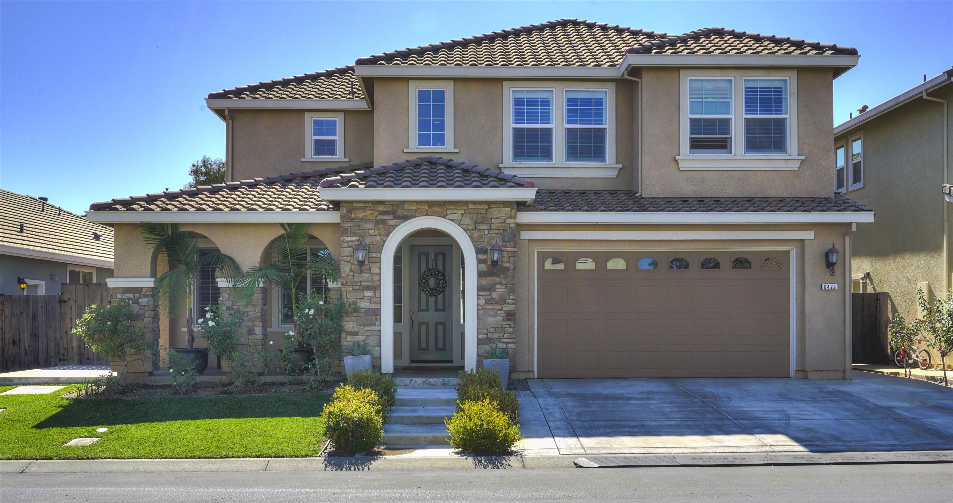 a front view of a house with garden