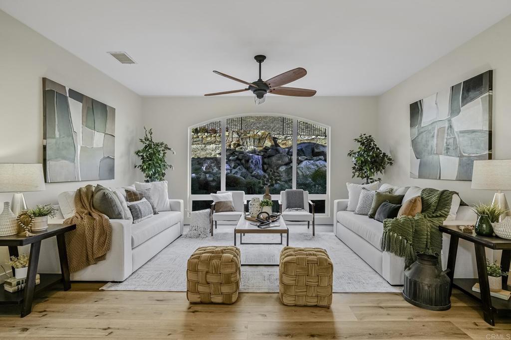 a living room with fireplace furniture and a large window