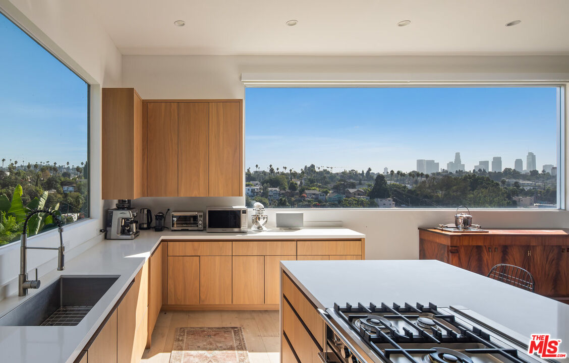 a large kitchen with a large window and a sink