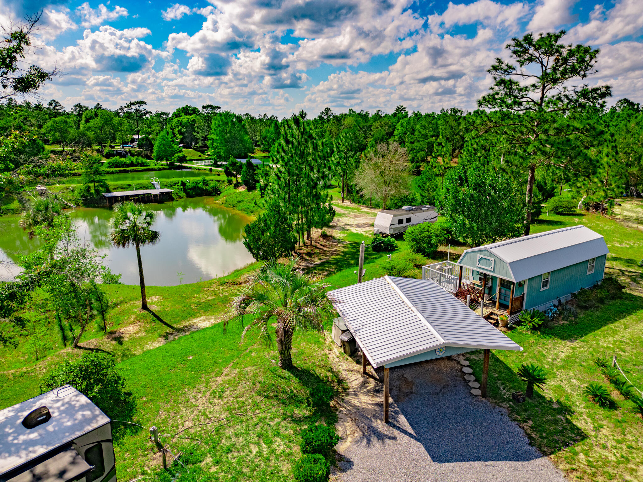 an aerial view of a house with yard and outdoor seating