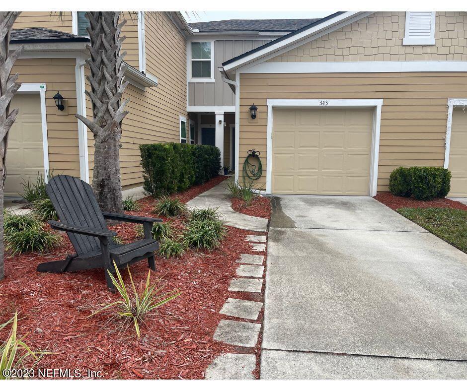 a view of a house with a yard and sitting area