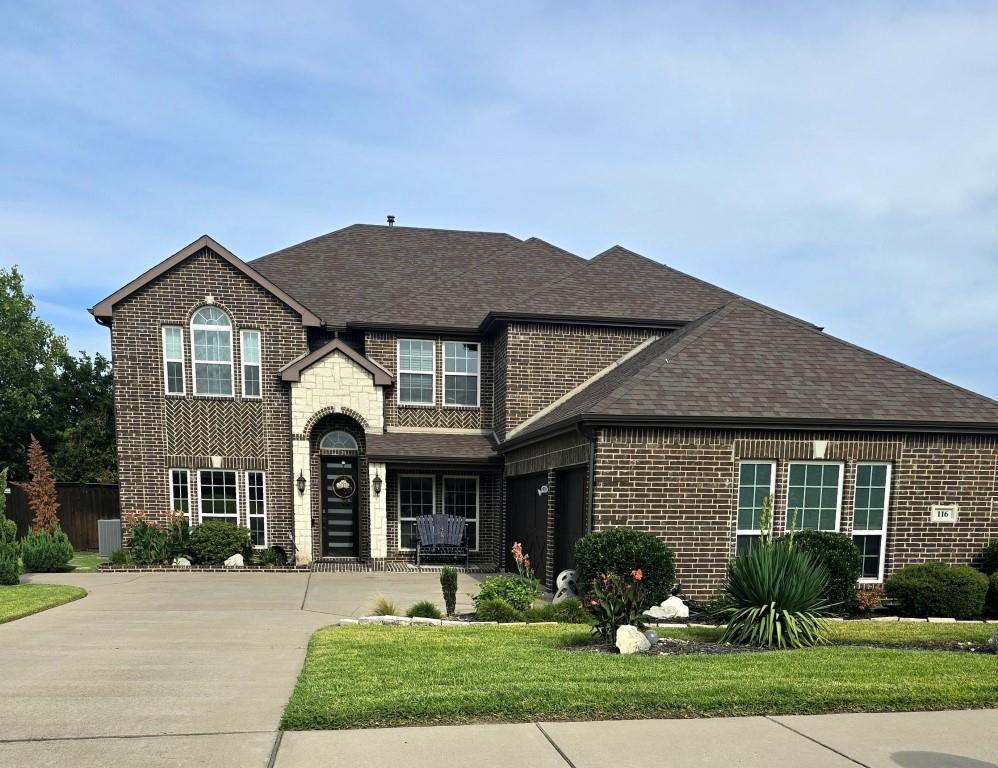 a front view of a house with garden