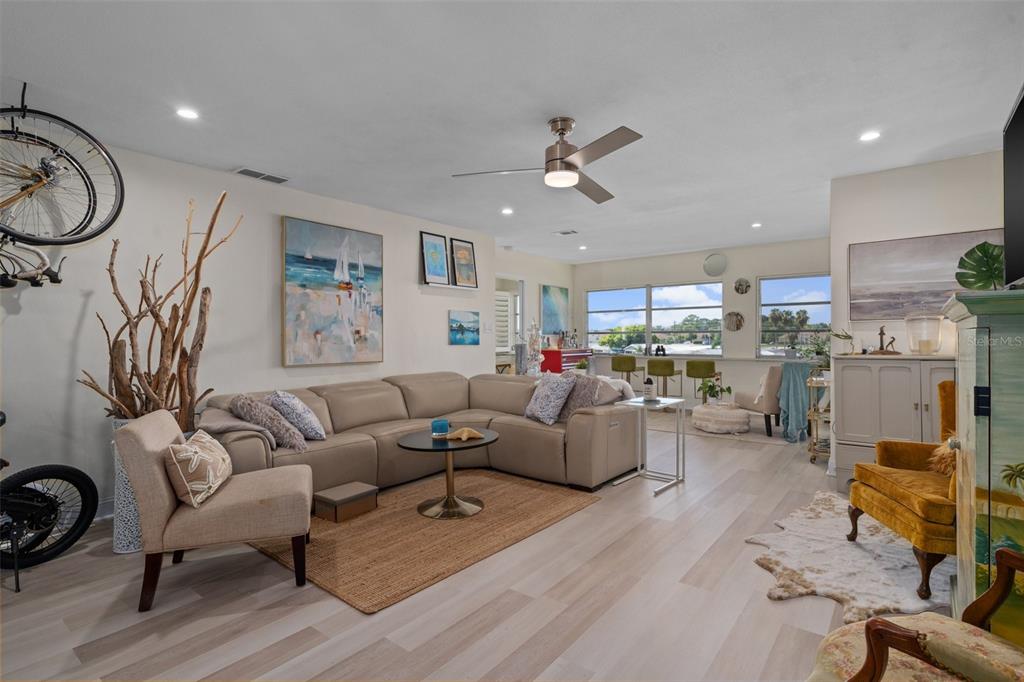 a living room with furniture and kitchen view