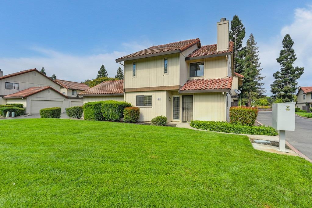 a front view of a house with a garden