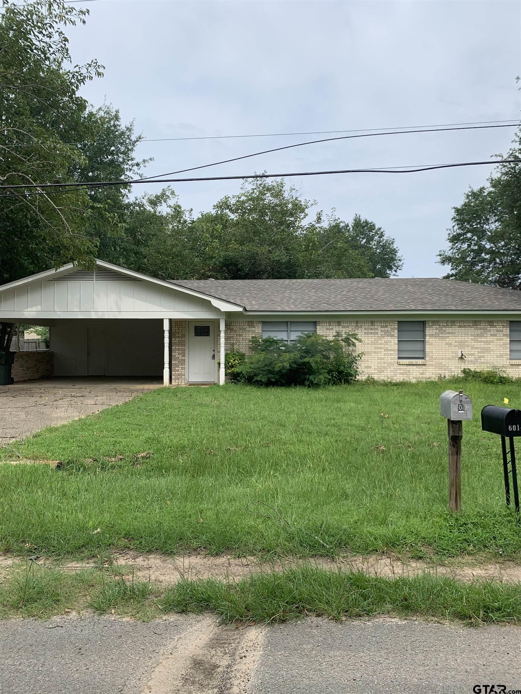 a front view of house with a garden