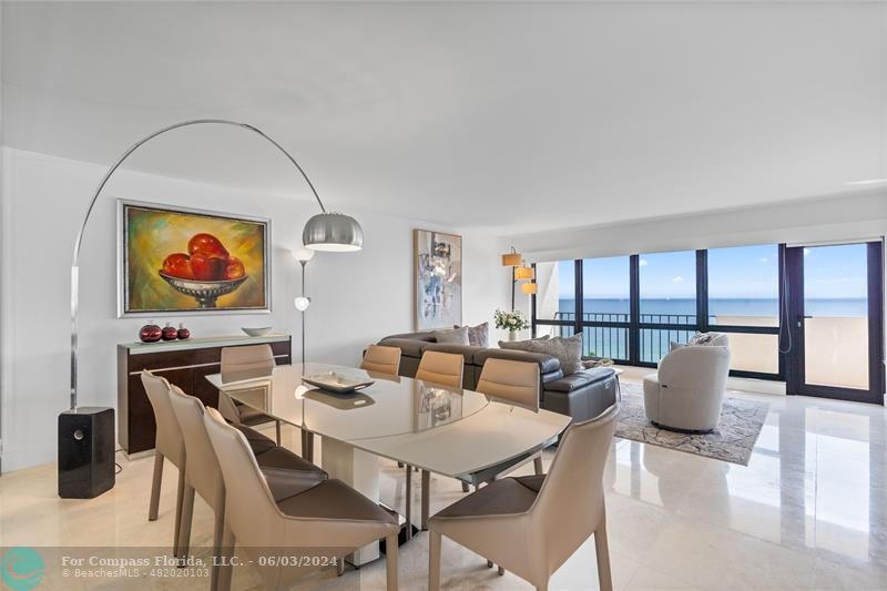 a view of a dining room with furniture large window and glass door