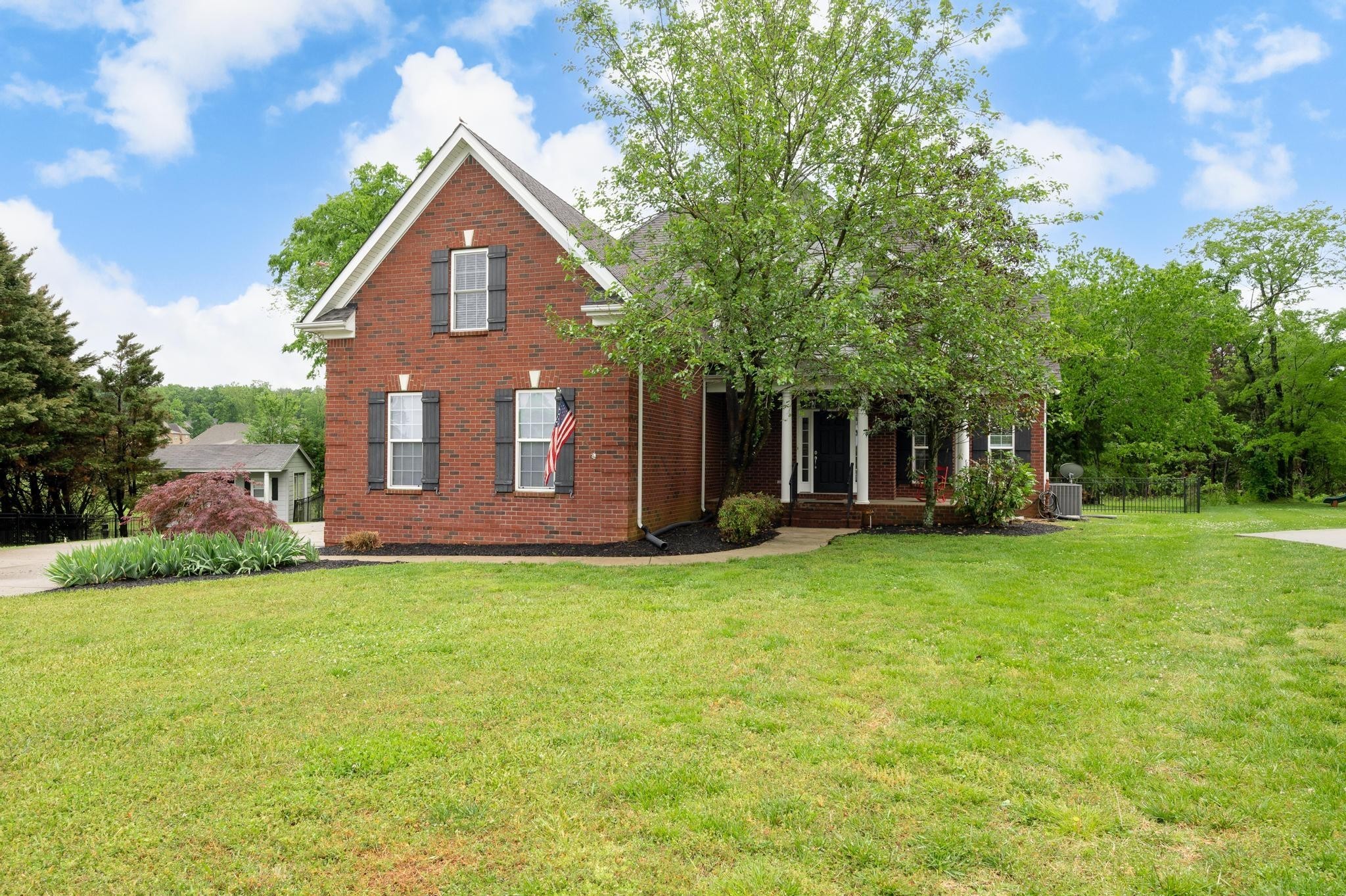 a front view of a house with a garden