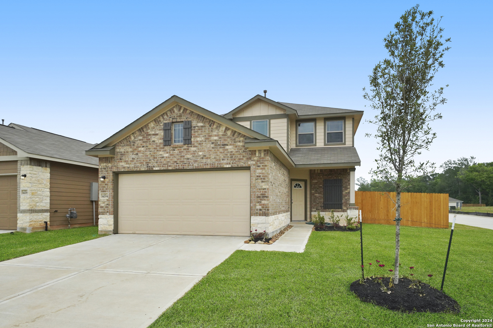 a front view of house with a garden