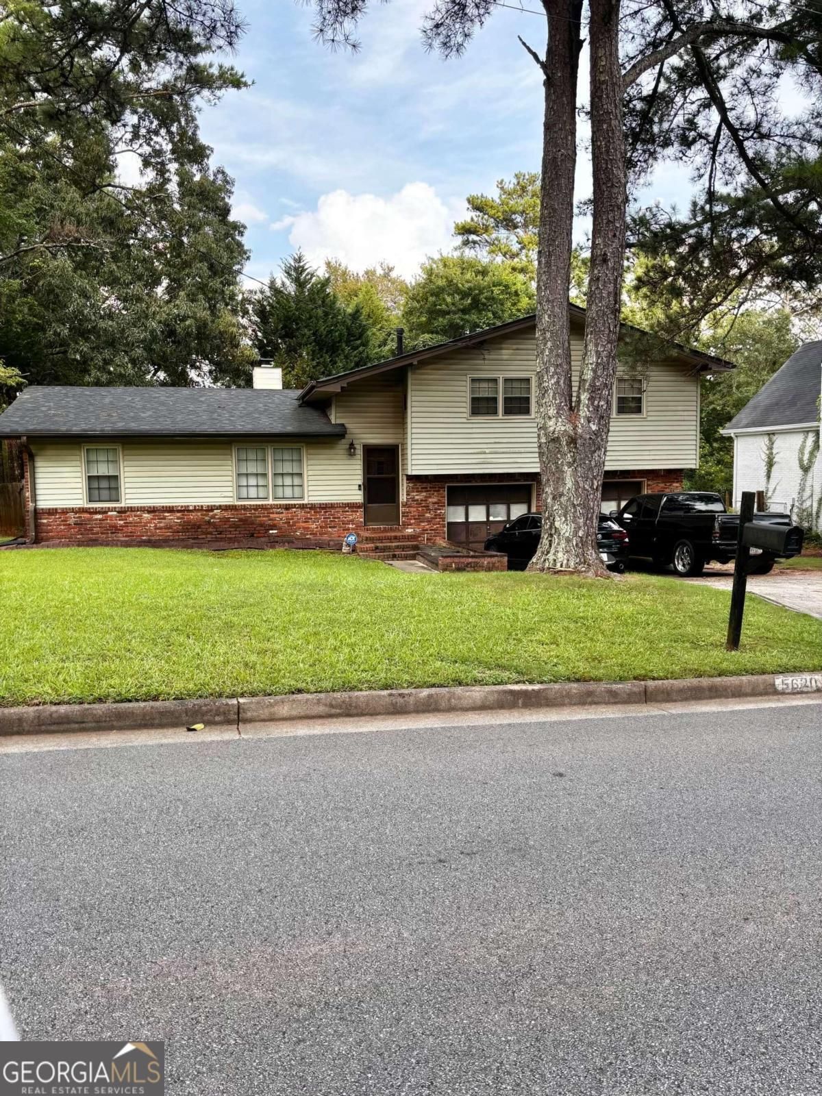 a front view of house with yard and green space