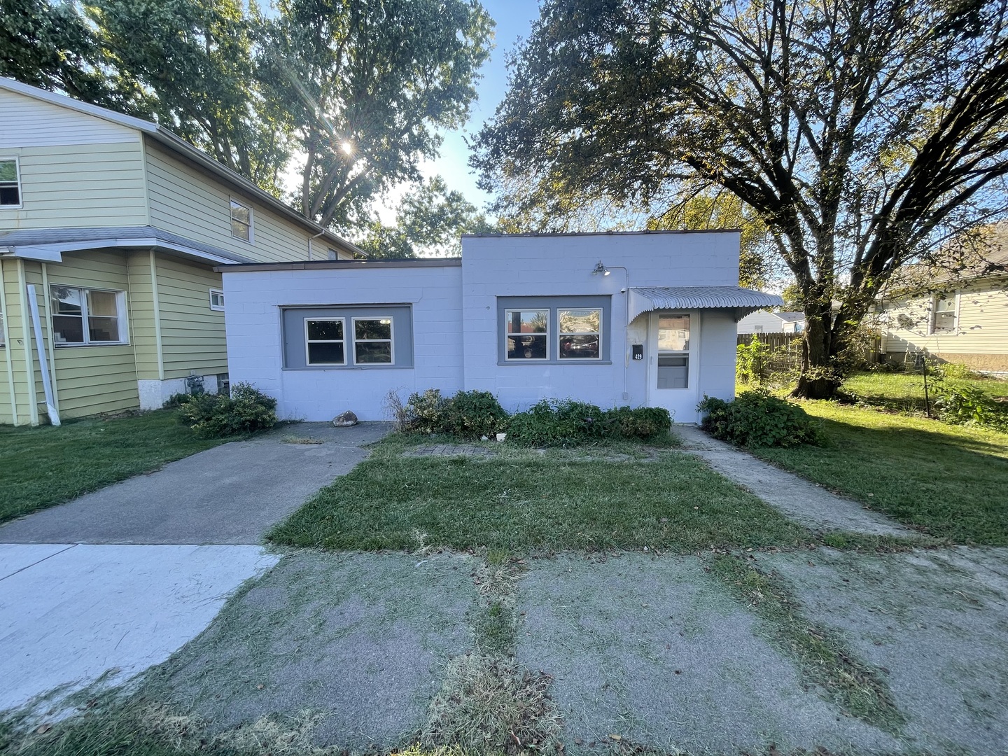 a front view of a house with a garden