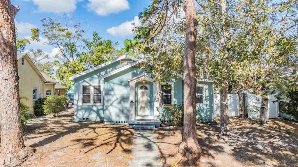 a view of a house with a tree in the background