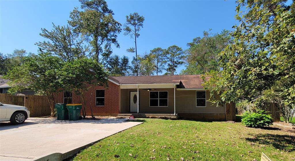 a view of a house with a yard and tree s