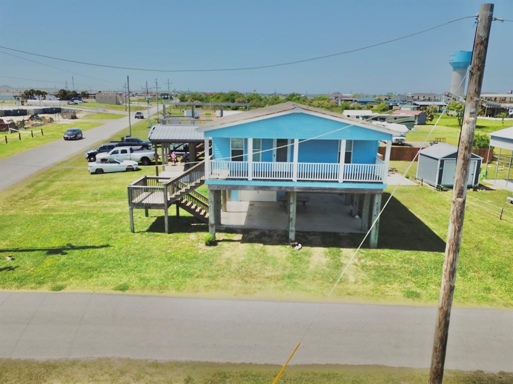 a view of a swimming pool with an outdoor seating and a yard